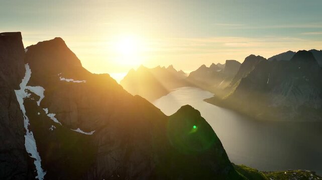 Aerial shot of the ocean meeting the mountains along the beautiful coast of Northern Norway near the town of Reine