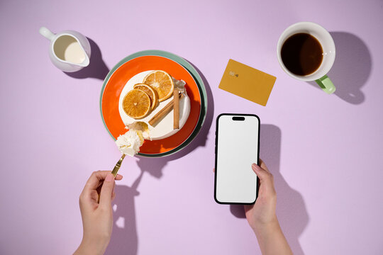 Overhead shot of a dessert with coffee and a phone