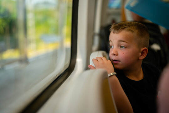 boy looking out train window
