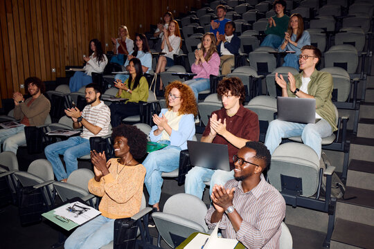 Students applaud at the end of a lecture
