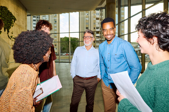 Students engage in conversation with their professor