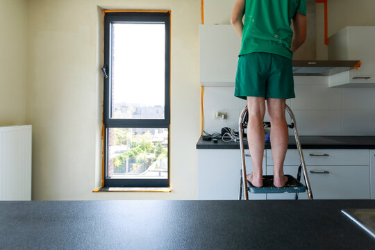 Person Standing on Ladder
