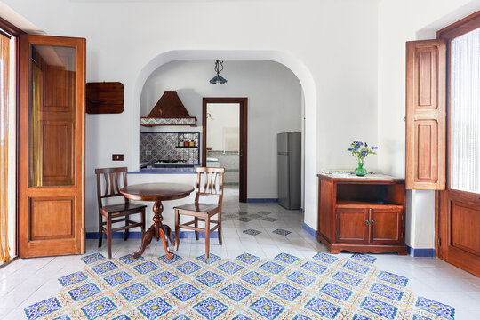 Patterned tiles lead into a sunlit Mediterranean kitchen