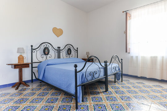 Simple Bedroom With Blue Bedding in Italy