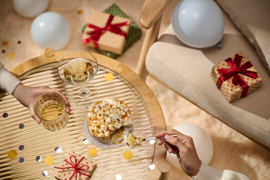 Celebration with cake, gifts, and drinks on a round table