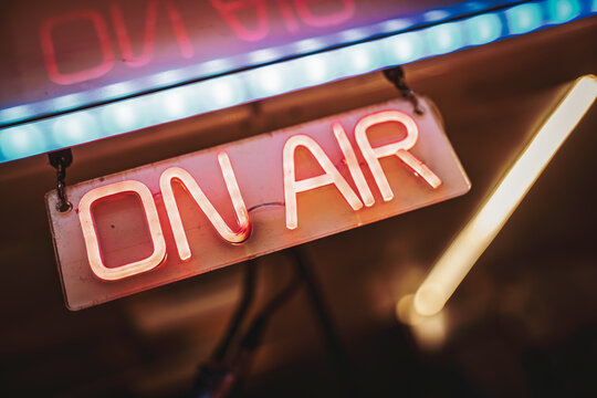 On air neon sign illuminating live broadcast studio