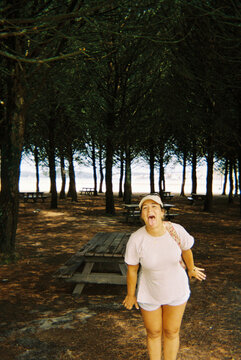 Woman making funny face in forest picnic area