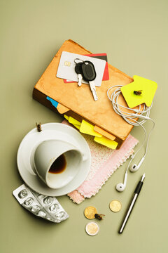 Messy pile of vintage book and coffee cup with daily objects