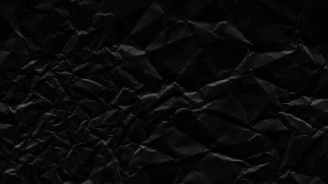 Halftone crumpled paper texture with wite a dotted, rough, and wrinkled surface. Black creased sheet background in comic pop-art style, featuring grainy folds and gritty distressed details