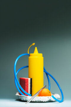 A Sculpture like pile of various objects on blue gradient background.