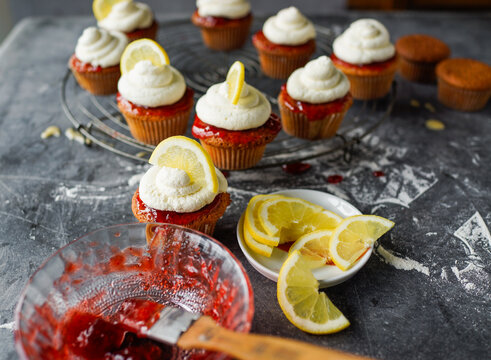 Delicious lemon cupcakes topped with creamy frosting and berry s