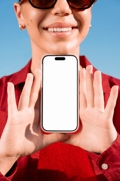 Woman with smartphone mockup and white screen against blue backdrop