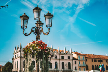 Ornate lamppost with flowers in european piazza © Filipo