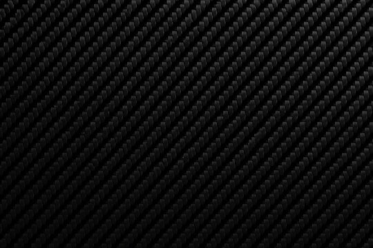 Carbon fiber texture showing diagonal weave on black surface