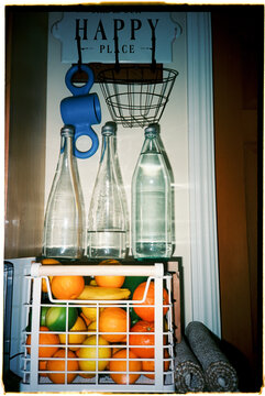Fruit and Water Placed in a Kitchen Setting on a Shelf