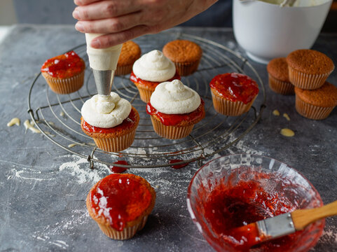 Creating delightful cupcakes with sweet toppings and creamy frosting