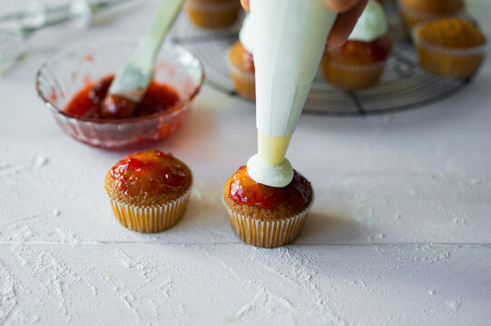 Creating delightful cupcakes with sweet toppings and cream