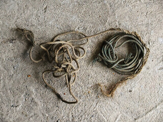 white background with a rope on an isolated gray wall © Saravut