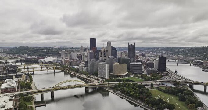 Pittsburgh Pennsylvania Aerial v120 flyover Point State Park at the confluence of three rivers through downtown, capturing the cityscape under cloudy sky - Shot with 5k Camera - Sept 25th 2023