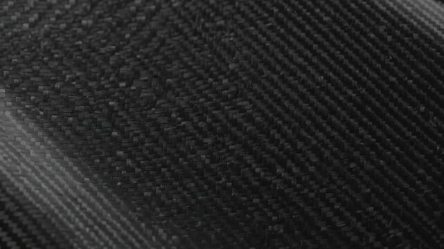 Dark black carbon fiber pattern texture background with metallic gloss