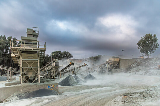 Industrial gravel sorting machinery with conveyor belts in a stone quarry