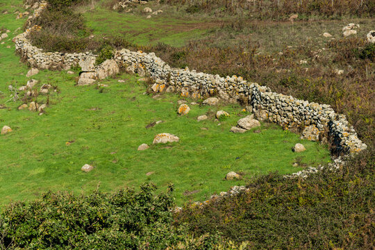 Italy, Sardinia, Macomer. Ramshackle stone walls delineating farm fields.