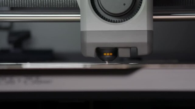 Machine moves steadily across flat surface. Precision tool glows softly, indicating operation. Close-up captures mechanical detail with clarity. Ideal for tech, manufacturing, or industrial themes