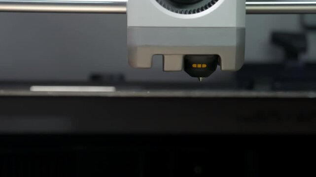 Machine moves steadily across flat surface. Precision tool glows softly, indicating operation. Close-up captures mechanical detail with clarity. Ideal for tech, manufacturing, or industrial themes