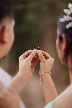 couple holding the wedding ring