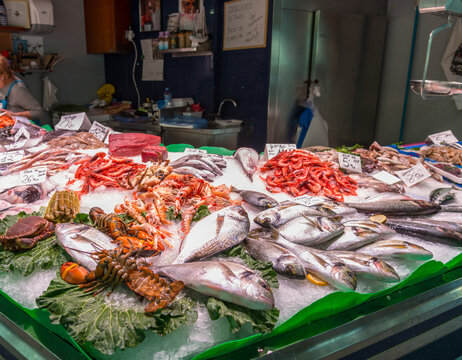 Spain, Barcelona.  Fresh fish and other seafoods on display at public market.