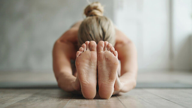 Woman performing yoga stretch in studio with copy space