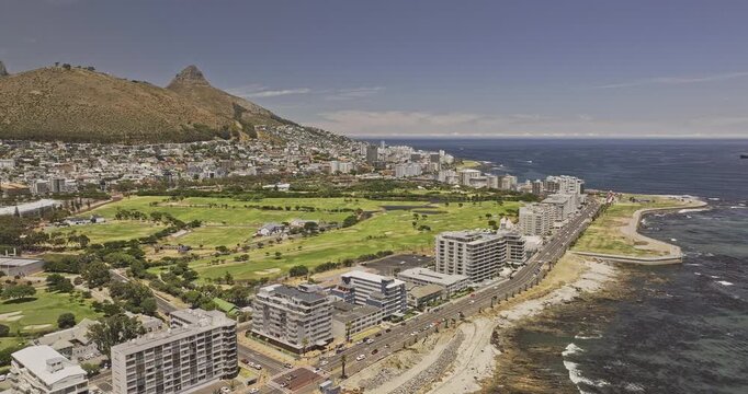 Cape Town South Africa Aerial v40 flyover the shoreline capturing the DHL Stadium, urban development, a green belt against the Table Mountain backdrop - Shot with 5k Camera - Jan 11th 2024
