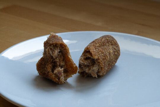 Breaded Croquettes Cut Open on a White Plate