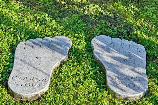 Stone footprints in grass with inscriptions Czarna Stopa and Black Foot.