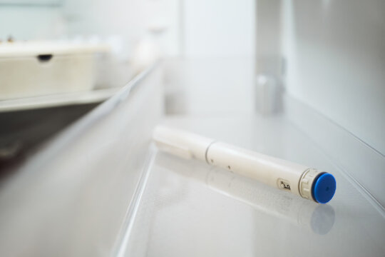 GLP-1 injection pen stored in home refrigerator, weekly medication therapy integrated into everyday life