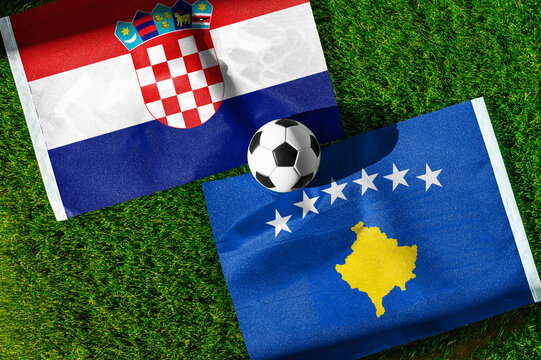 Croatia vs. Kosovo football match. National flags on green grass with soccer ball in the middle. Football background for international match.