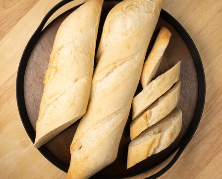 Freshly baked french baguettes on wooden tray