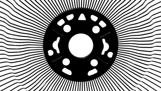 Abstract geometric black and white moire pattern from industrial fan grill structure isolated on clean white background