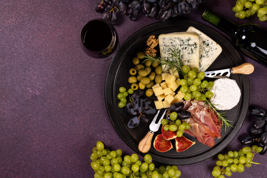 Wine and cheese board with grapes and appetizers
