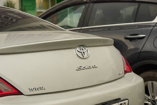 Tyumen, Russia-July 10, 2026: Detailed close up shot of a silver chrome Toyota Solara SLE model designation badge badge on a clean metallic vehicle trunk