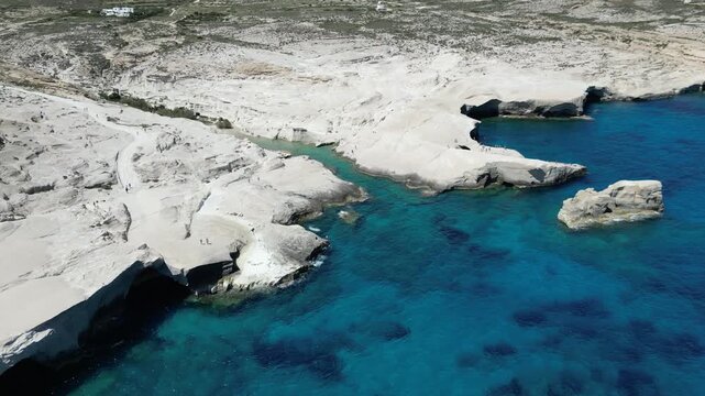 Top-Down Aerial Texture of White Rock Meeting Turquoise Sea at Sarakiniko, Milos, Greece