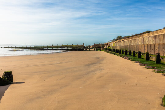 Wooden and concrete groynes are used along the beach at Walton-on-the-Naze as a form of hard coastal engineering to stop longshore drift and reduce beach erosion. Shot 21 September 2026.