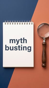 Myth busting concept with open notebook and magnifying glass on dual-tone background