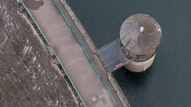Aerial view of the Sengbachtalsperre dam featuring its stone wall, water intake tower, and reservoir in Solingen, Nordrhein-Westfalen, Germany.