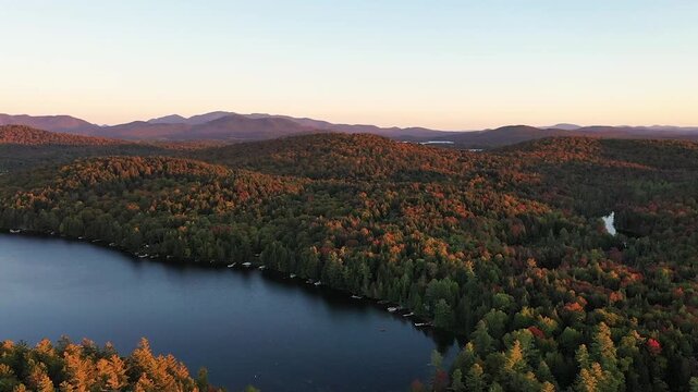 Sunset in early fall over Fish Creek Bay to Fish Creek Pond NY Adirondacks aerial drone panning East to West