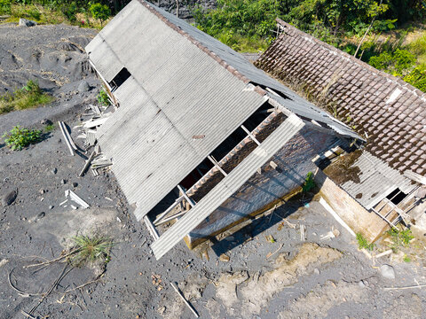 Aerial view of a damaged house in Supiturang Village covered in volcanic ash following the catastrophic eruption of Mount Semeru in Pronojiwo, East Java, Indonesia.