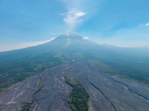 Aerial view of Mount Semeru showing the volcanic landscape and lava flow paths following a catastrophic eruption in Pronojiwo, East Java, Indonesia.