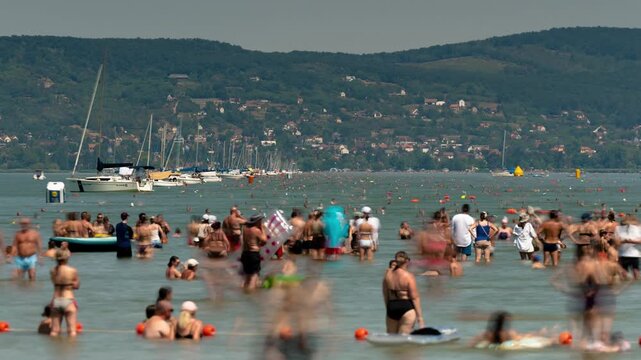 Balatonboglar Lake Balaton shoreline timelapse showing sunny summer landscape with sailing boats and distant hills in Hungary