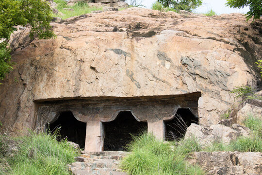 Impressive view of a historic rock-cut cave temple and ancient rock-cut architecture in Tamil Nadu, South India. This is an archaeological site.