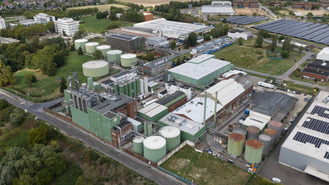 Monheim am Rhein, Germany - 04 September 2026: Aerial view of the UNIFERM GmbH Co. KG industrial facility featuring large storage tanks, production buildings, and surrounding green spaces.